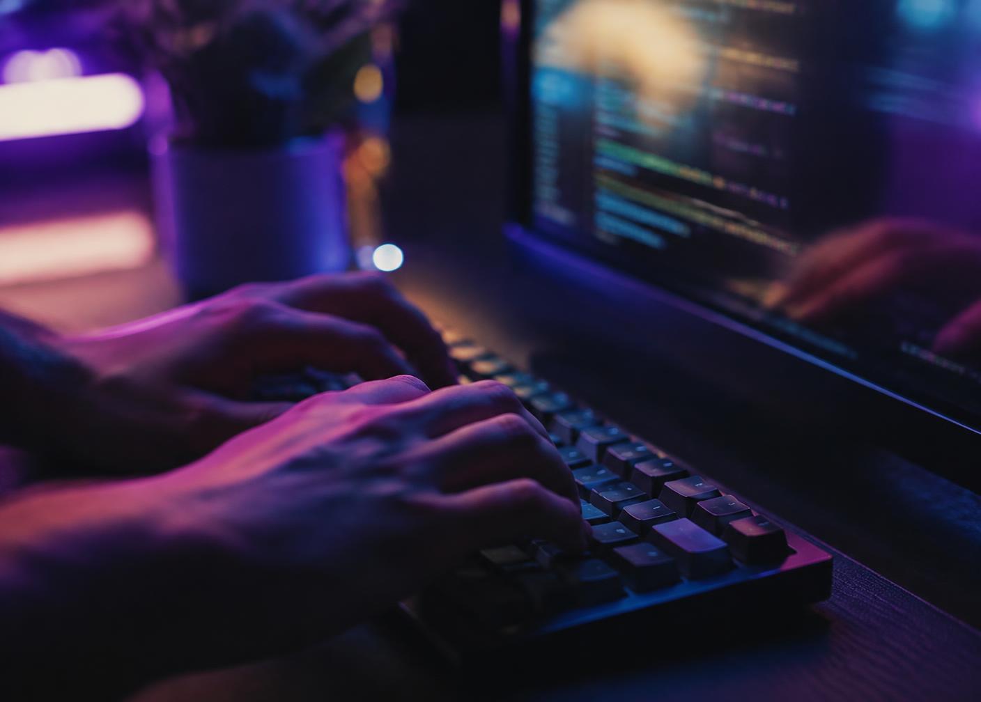 Developer's hands typing code on a mechanical keyboard
